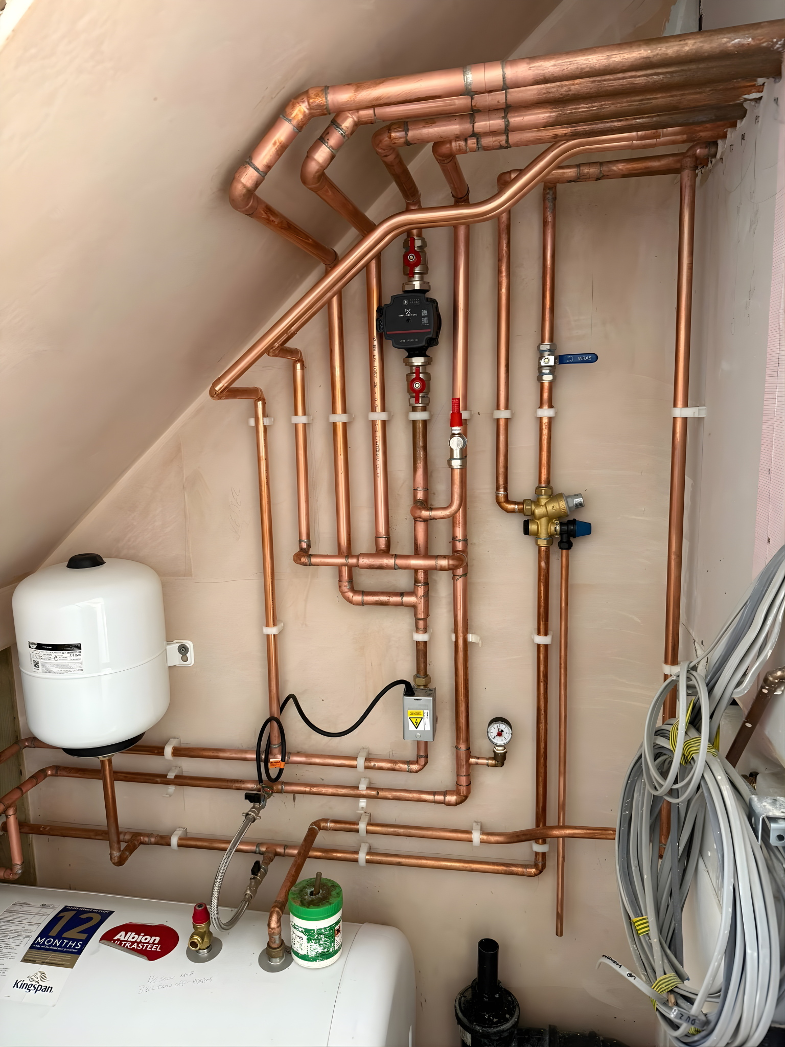 Close-up of neat boiler pipework and valves